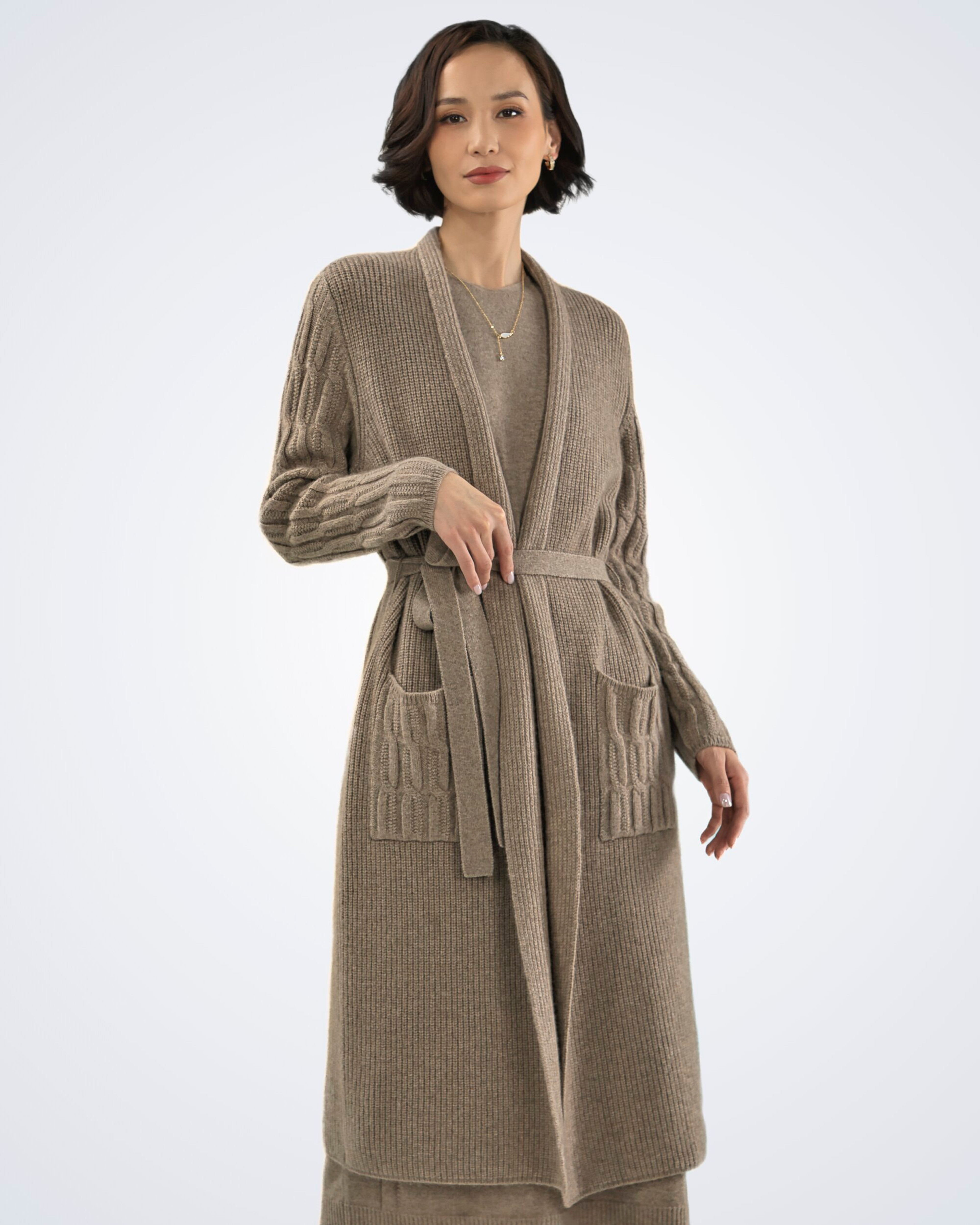 Unur model wearing a natural brown ribbed cashmere long cardigan with cable detail