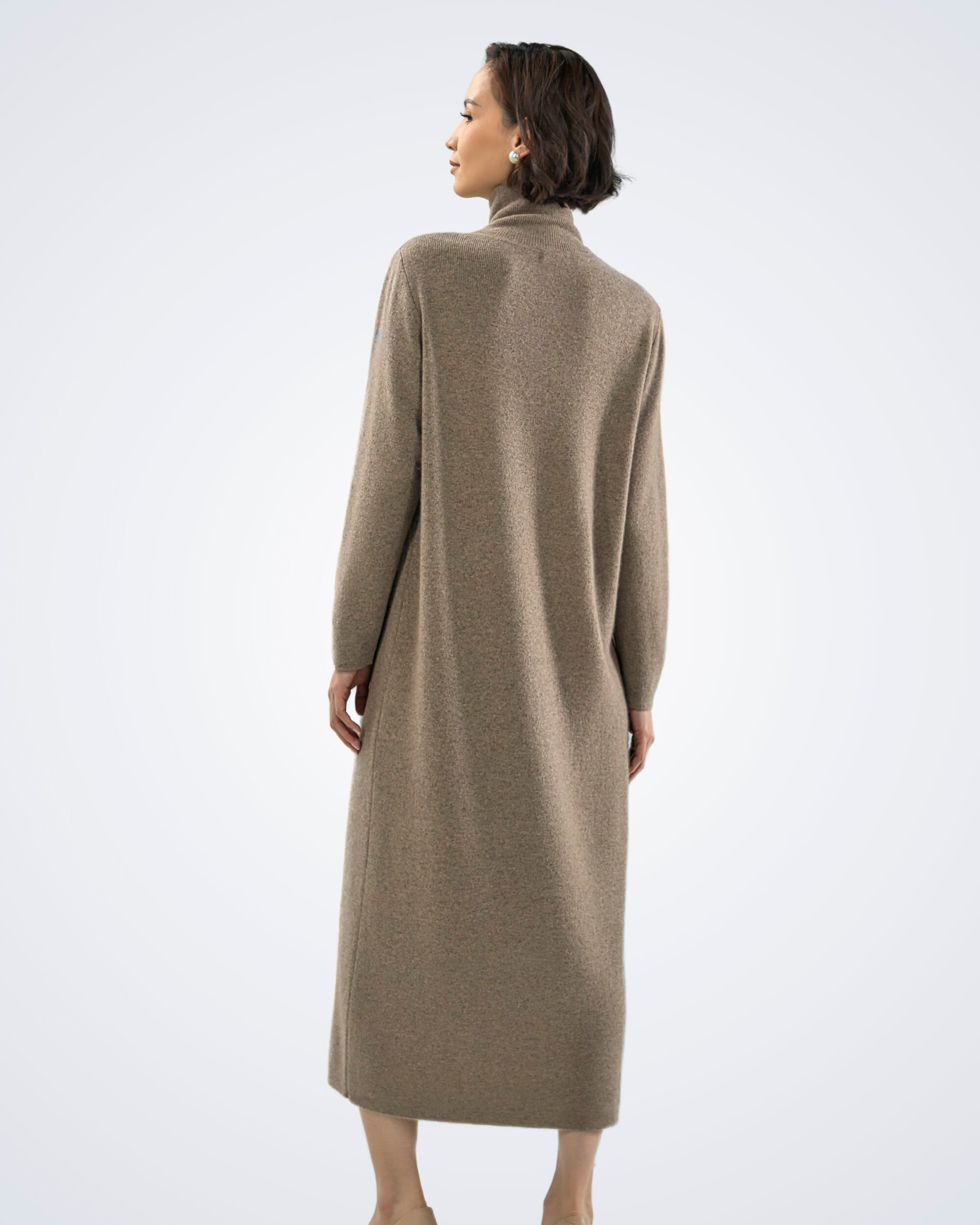 Unur model wearing a natural brown high neck long sleeved cashmere midi dress, rear view