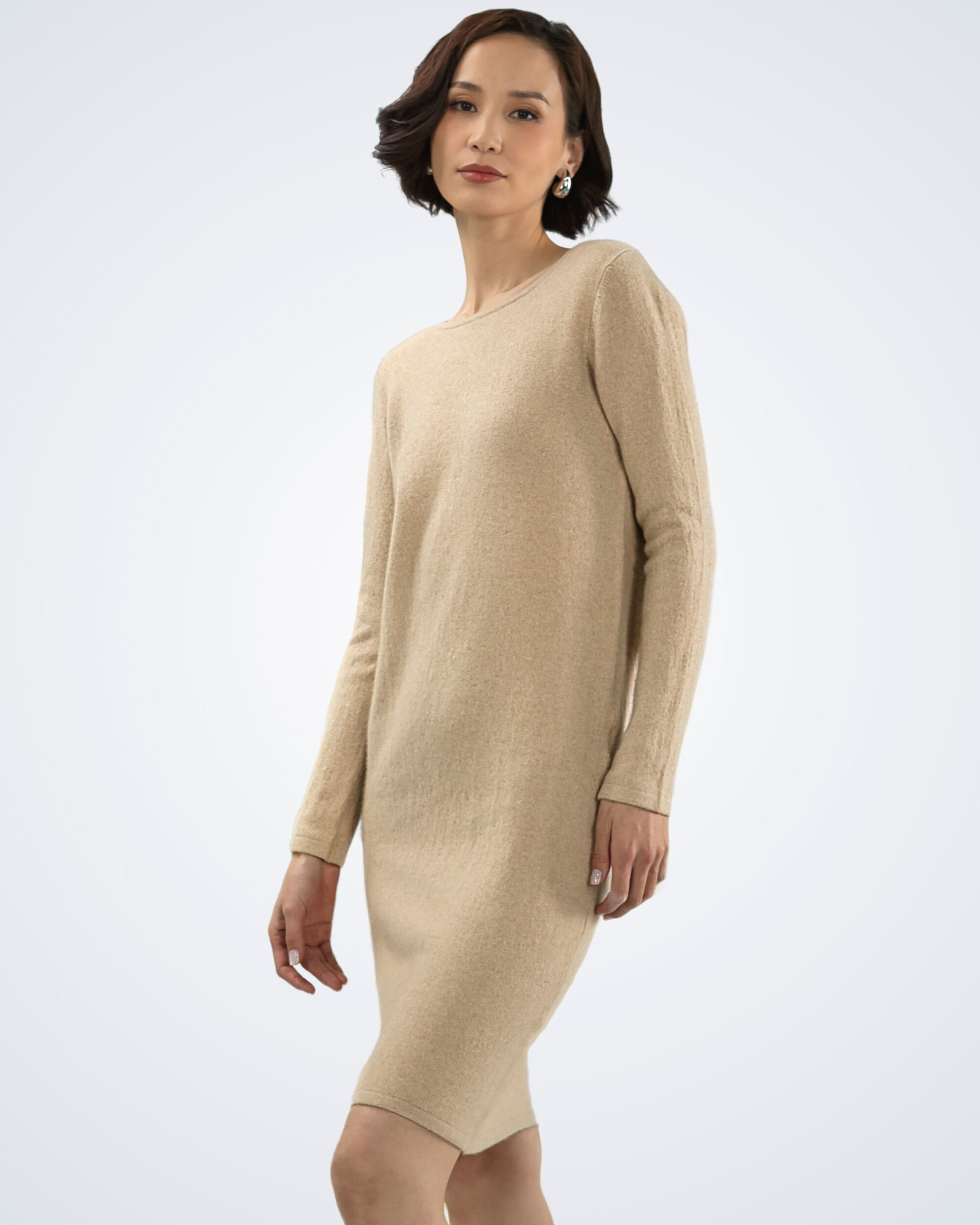 Unur model wearing a longsleeved cashmere shift dress in natural beige