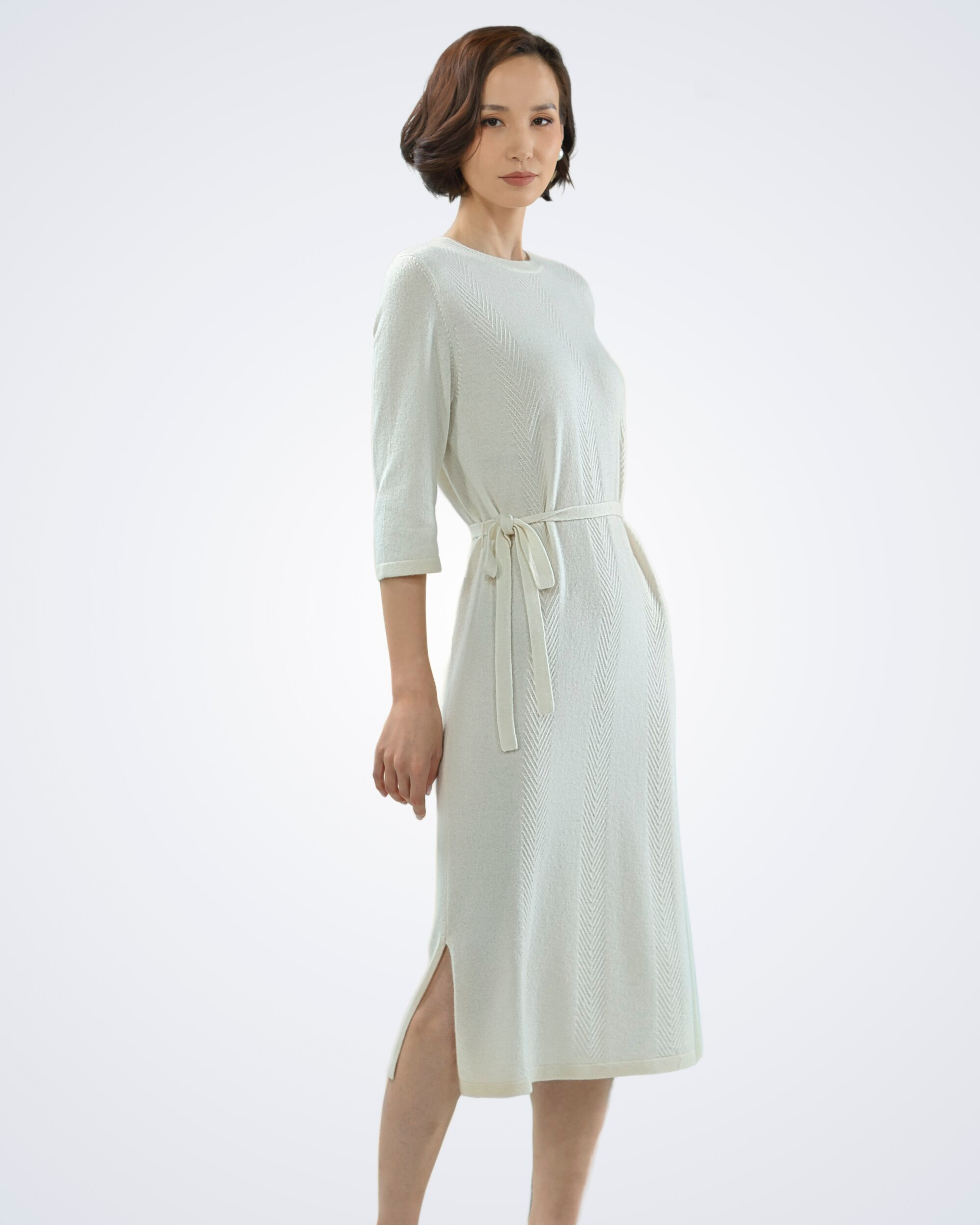 Unur model wearing a white three-quarter sleeve chevron cashmere midi dress