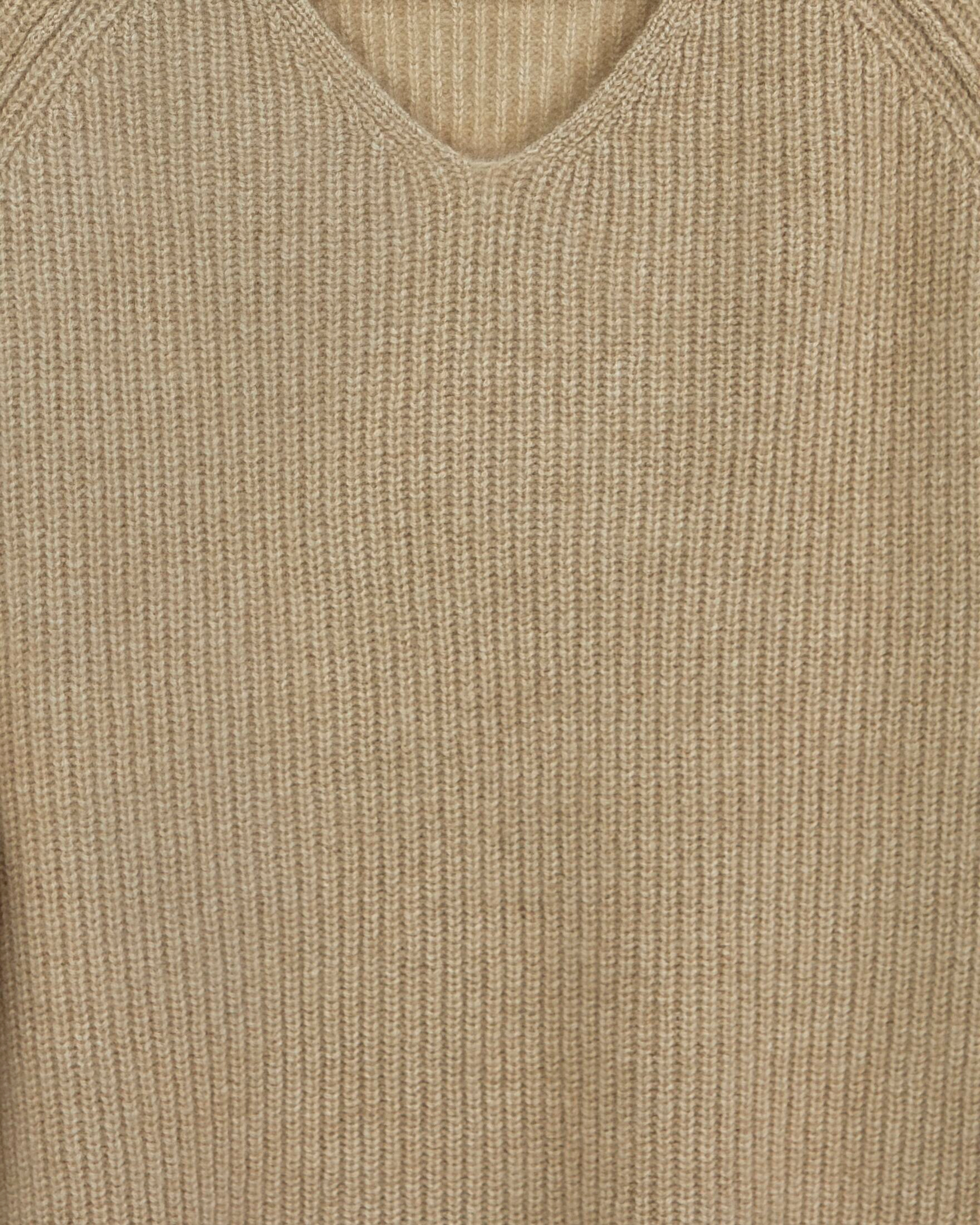 Close up of natural beige ribbed cashmere with exposed seams