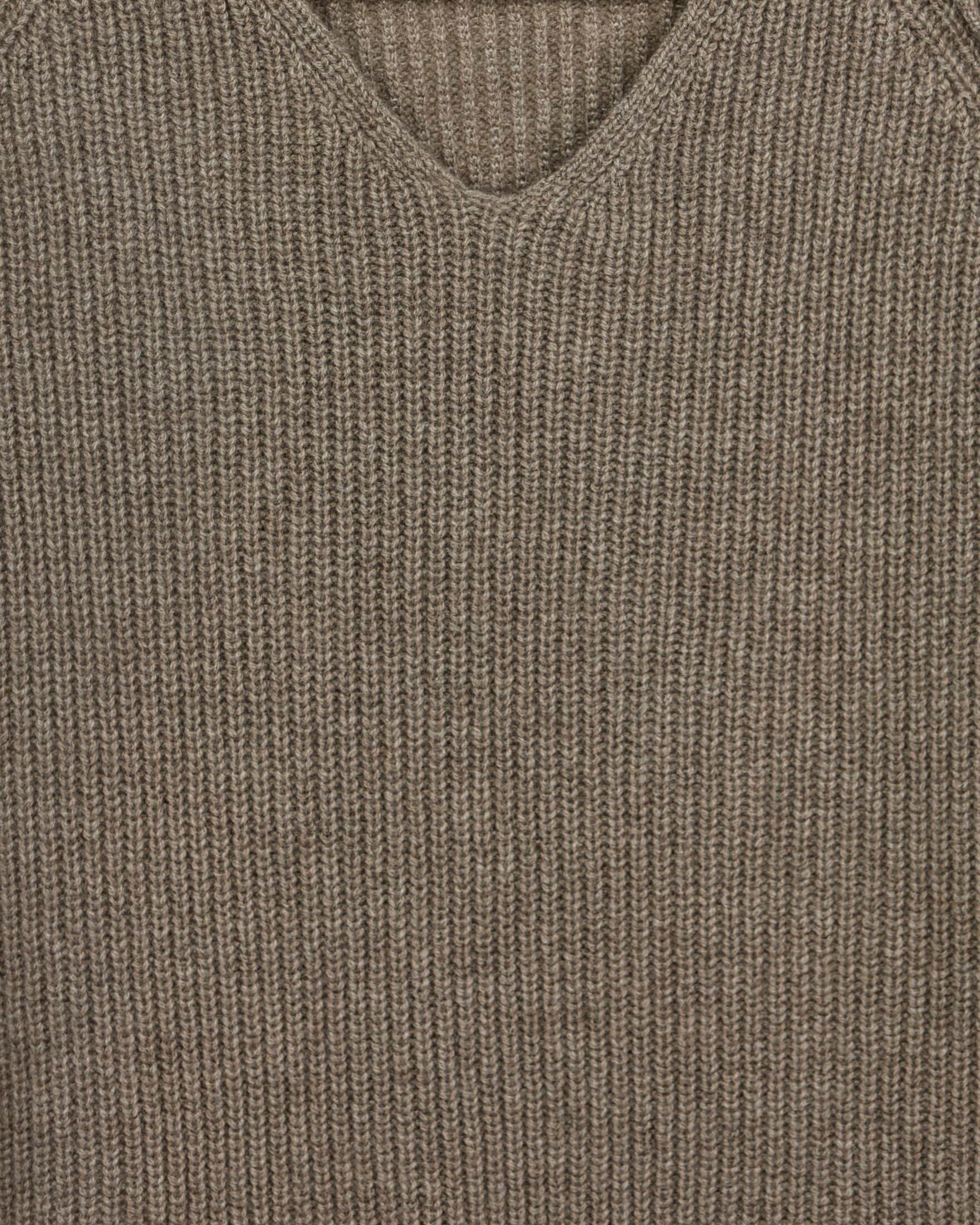 Close up of natural brown ribbed cashmere with exposed seams