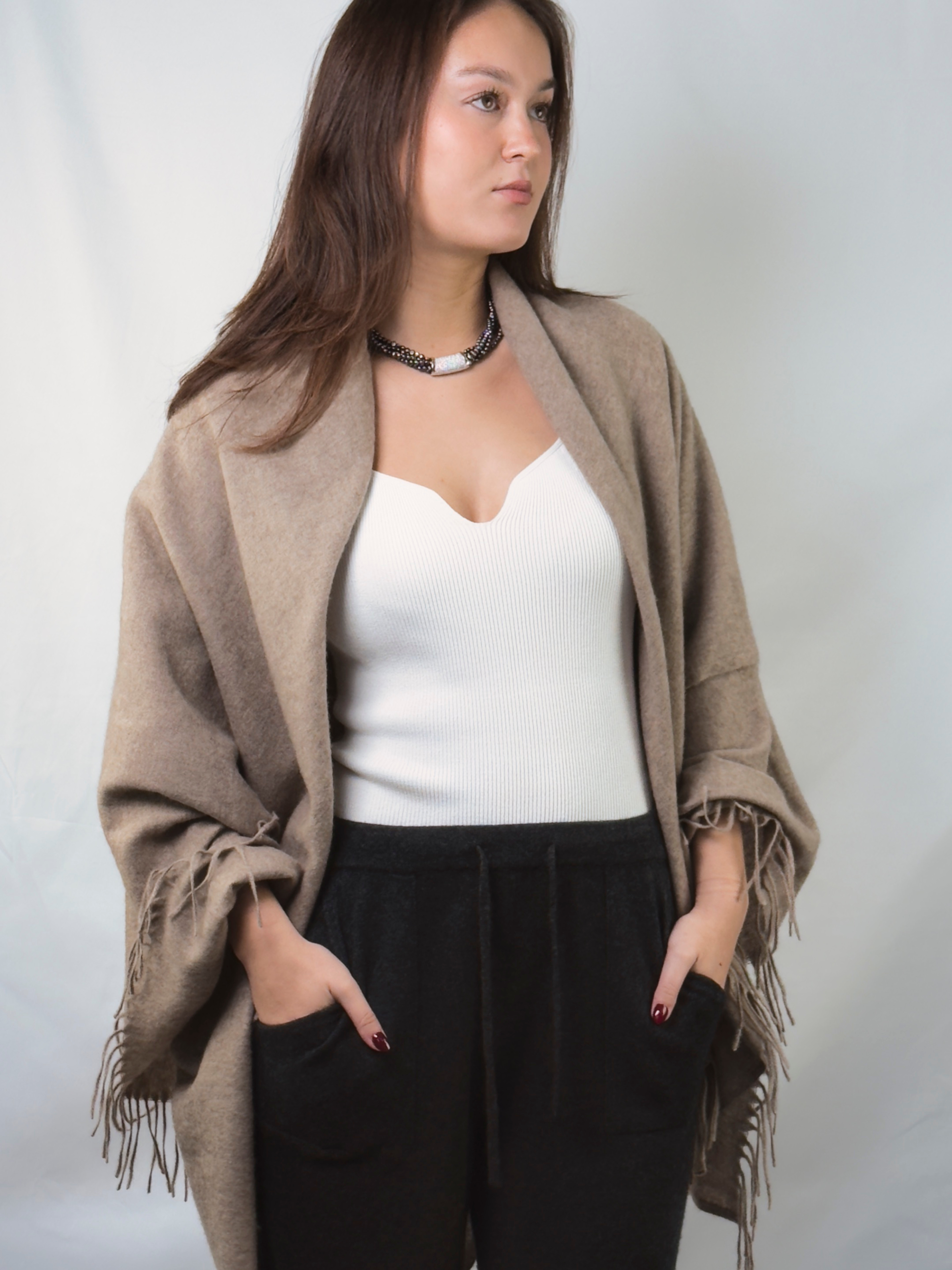 Model wearing a finely woven natural brown cashmere shawl