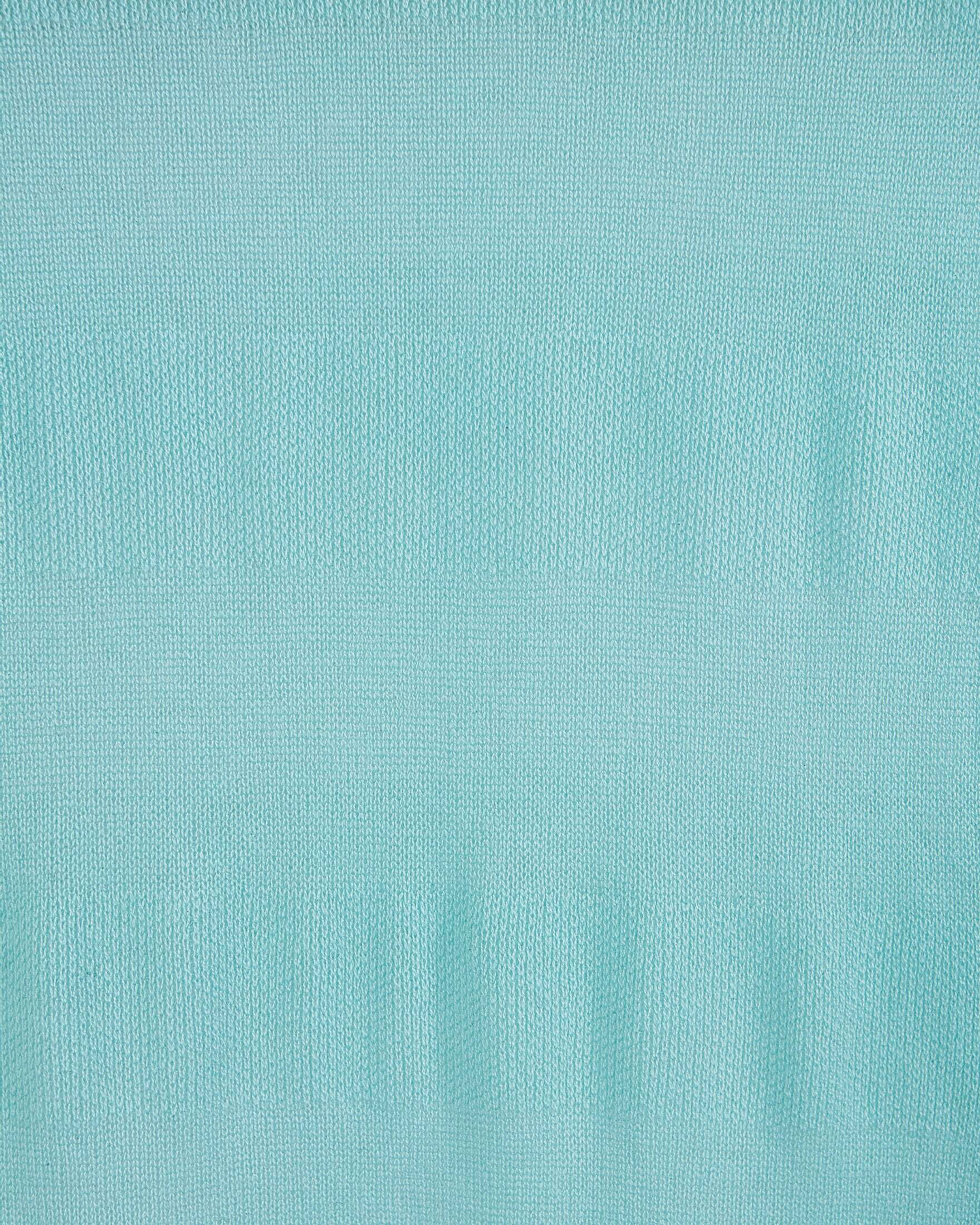Close up of a mint green cashmere shawl with a delicate patterned knit