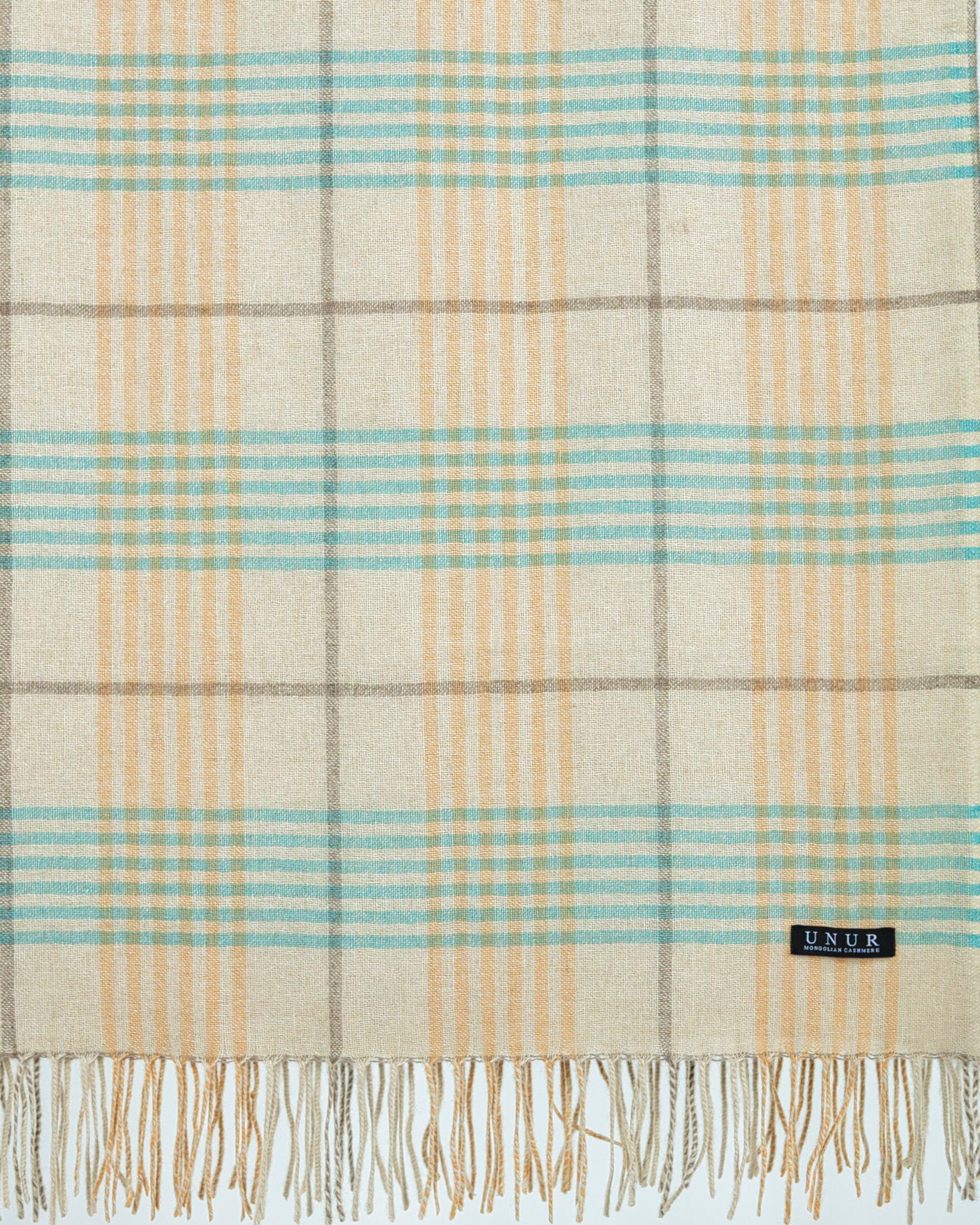 Close up of cashmere plaid wrap shawl with tasselled edges