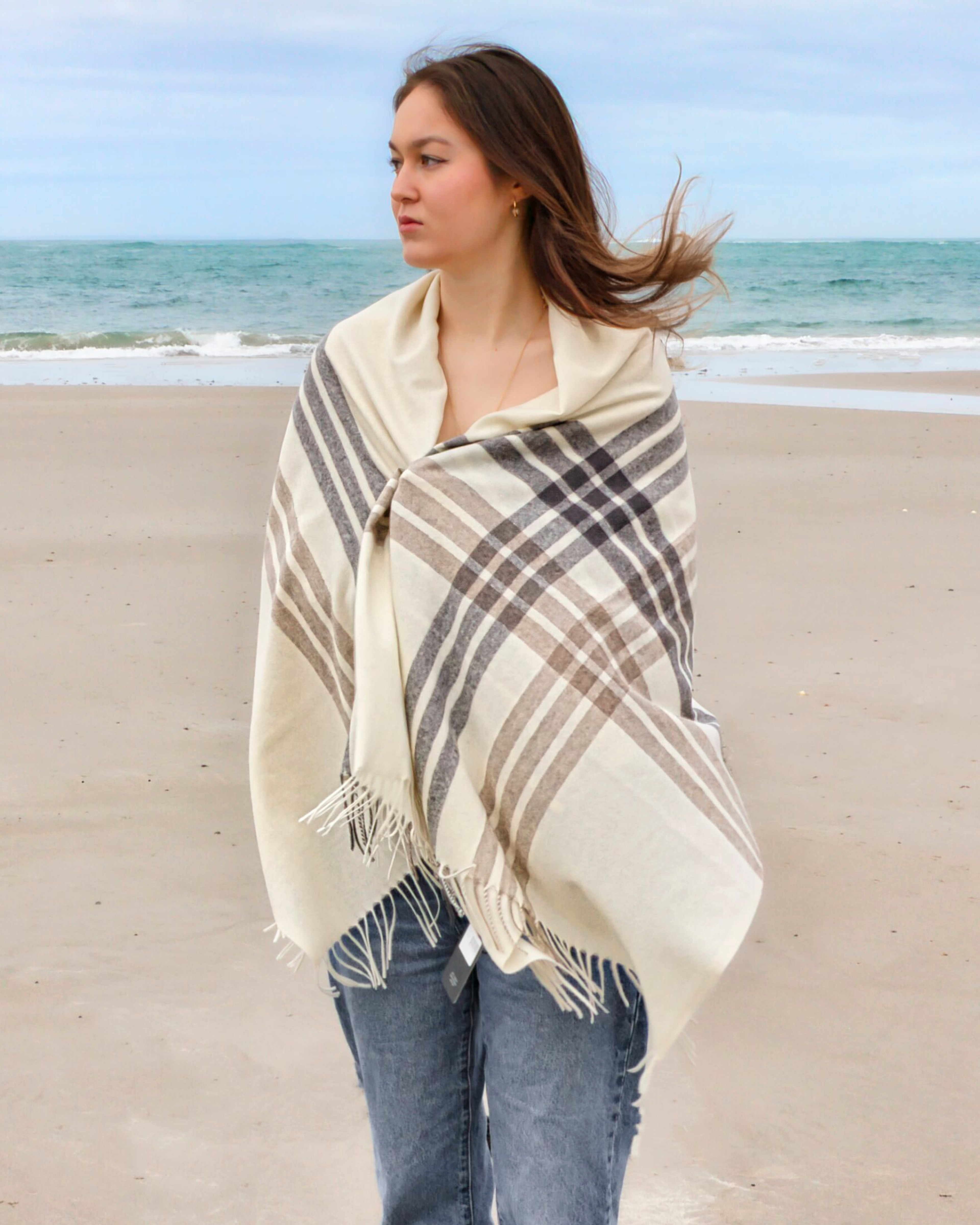 Model outdoors wearing women's white cashmere checked pattern shawl