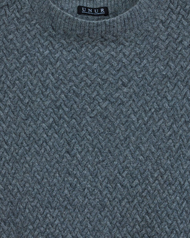 Close-up of a grey luxury cable knit cashmere vest