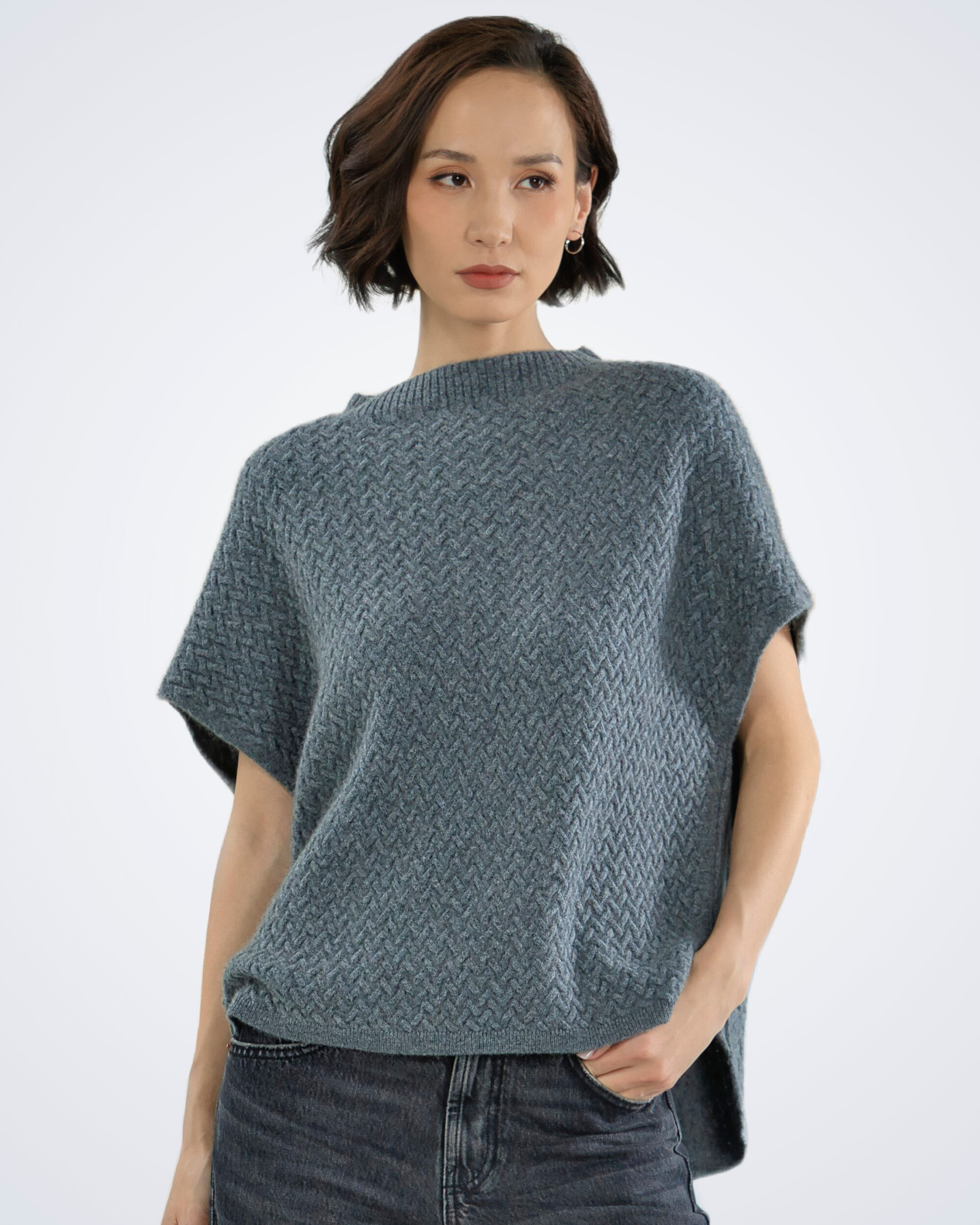 Unur model wearing a grey luxury cable knit cashmere vest