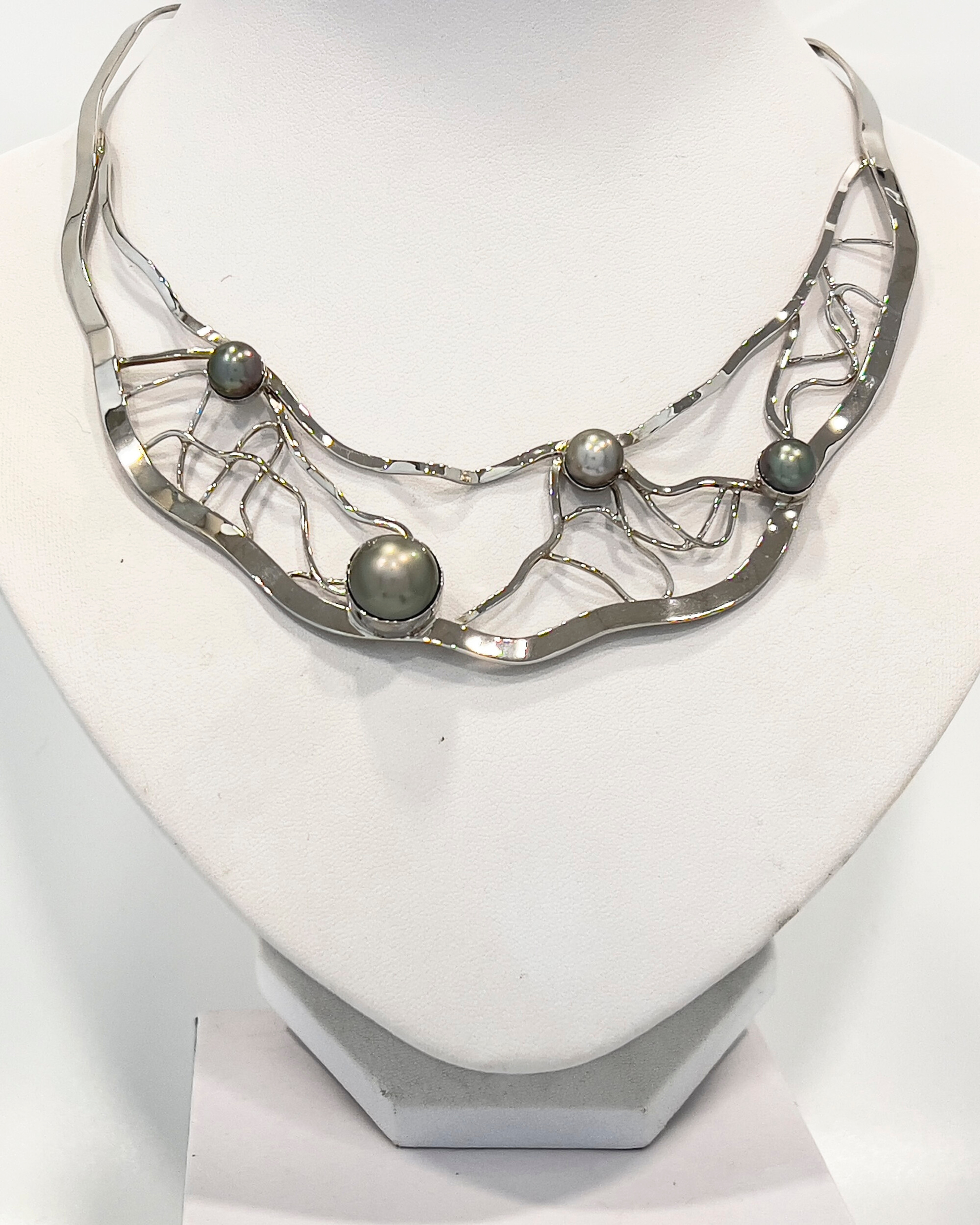 Signature Torque Collar Necklace with one large and three medium Tahitian pearls in a silver lattice