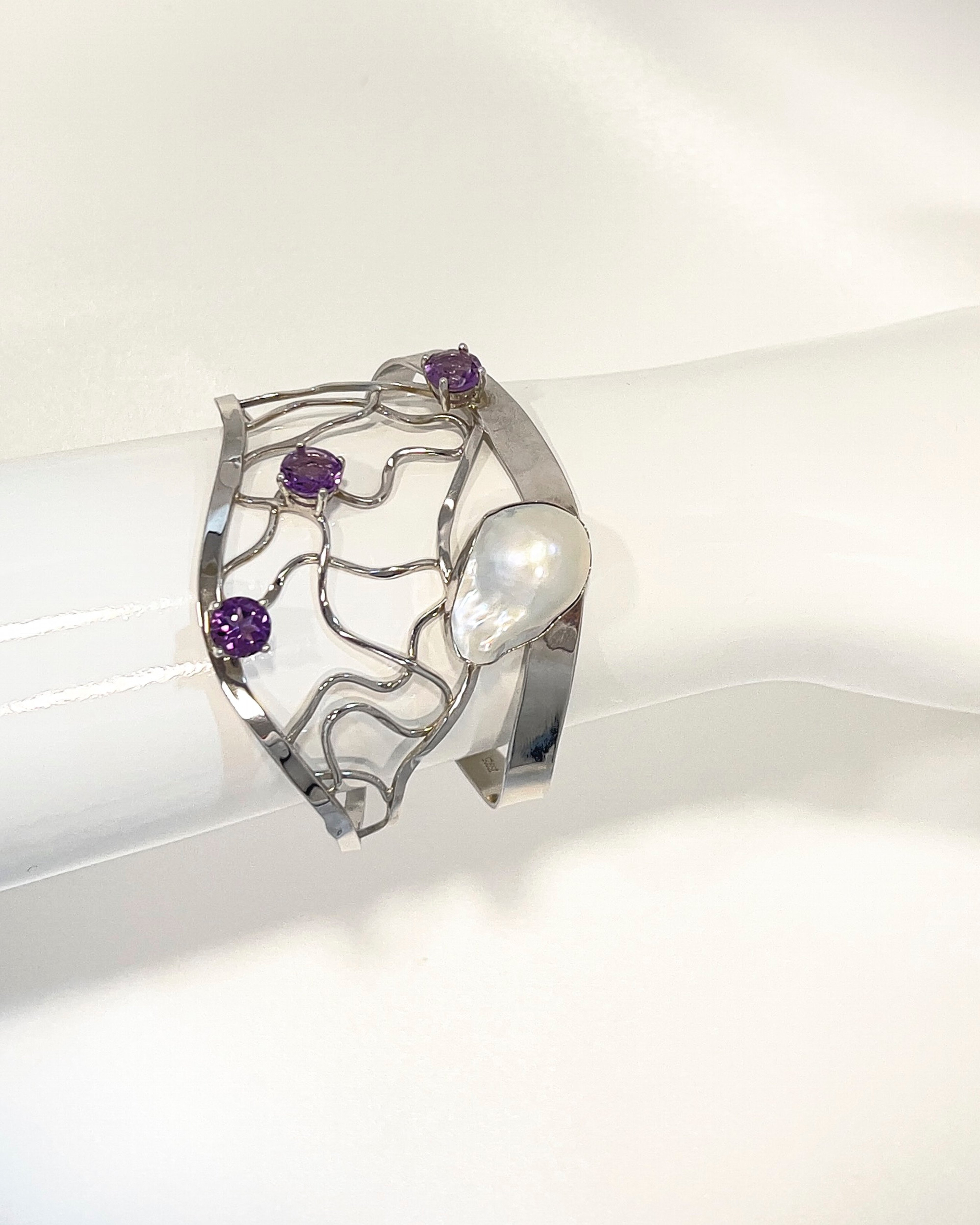 Elegant rhodium-plated sterling silver lattice bangle with a baroque pearl and three amethysts
