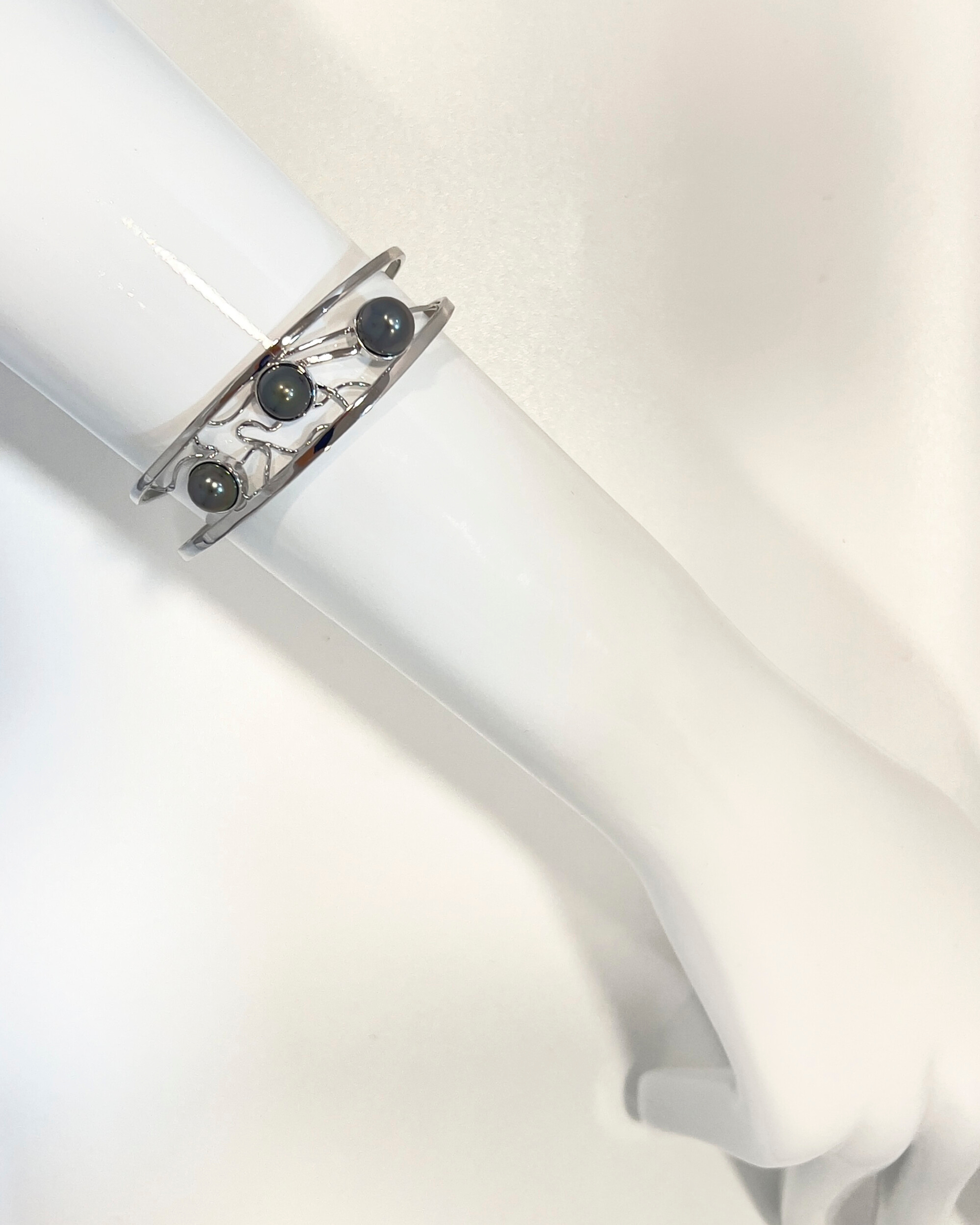 Signature double band silver bangle with three lustrous Tahitian pearls and delicate lattice detailing