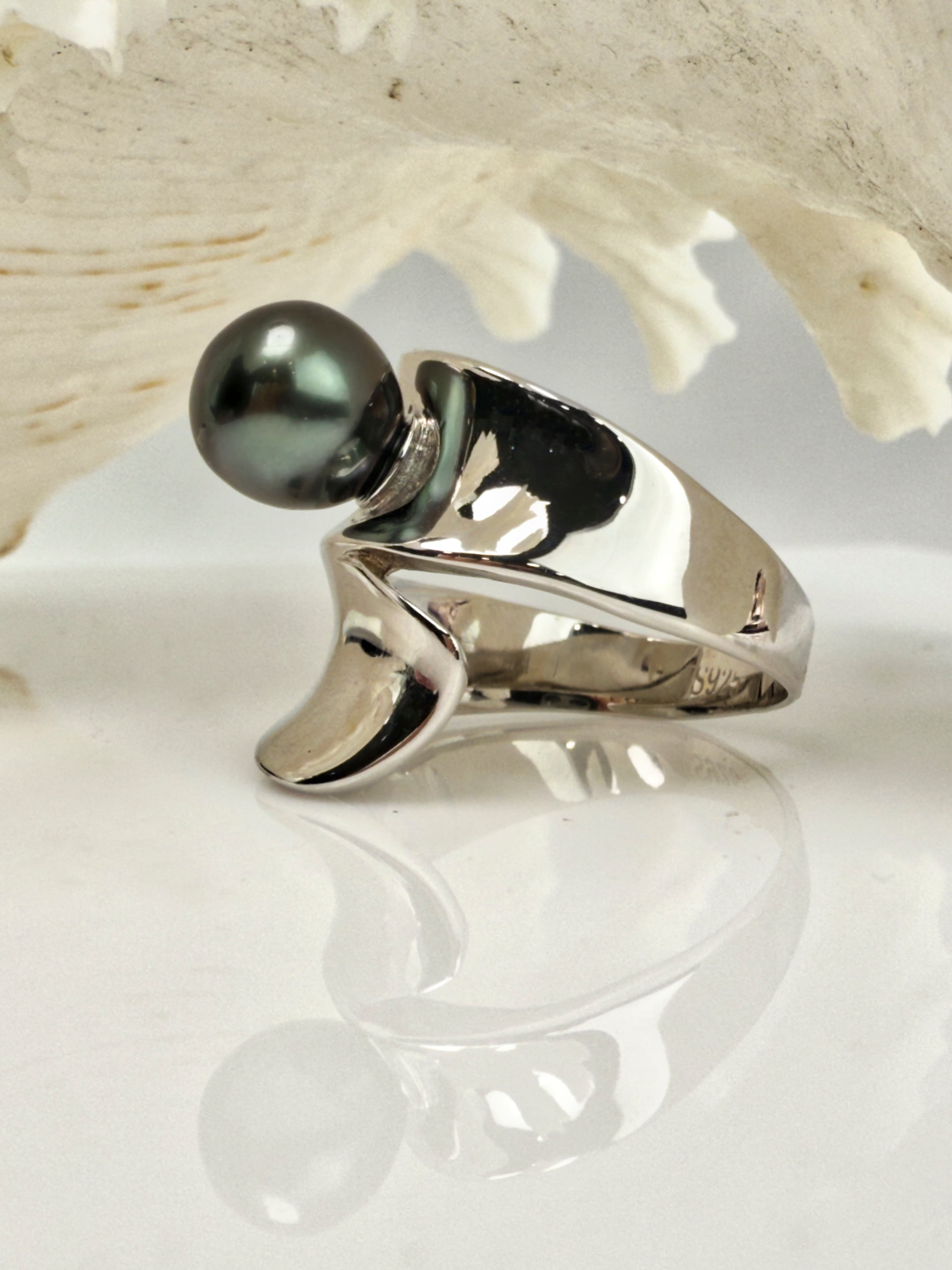 Signature Tahitian pearl statement ring with wrapped sterling silver band, set against coral