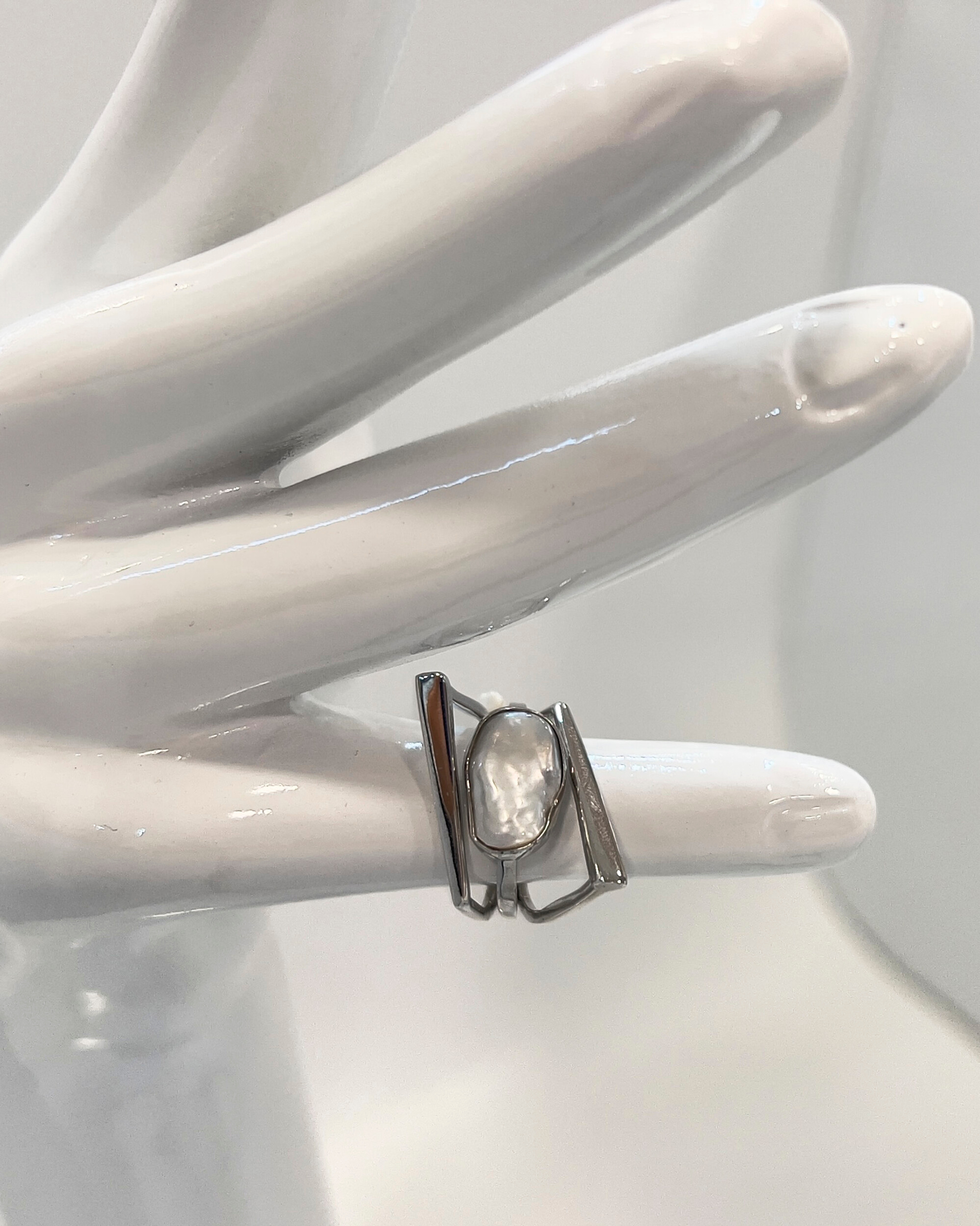 Unur Signature Statement Ring with an organic keshi pearl and parallel silver bands
