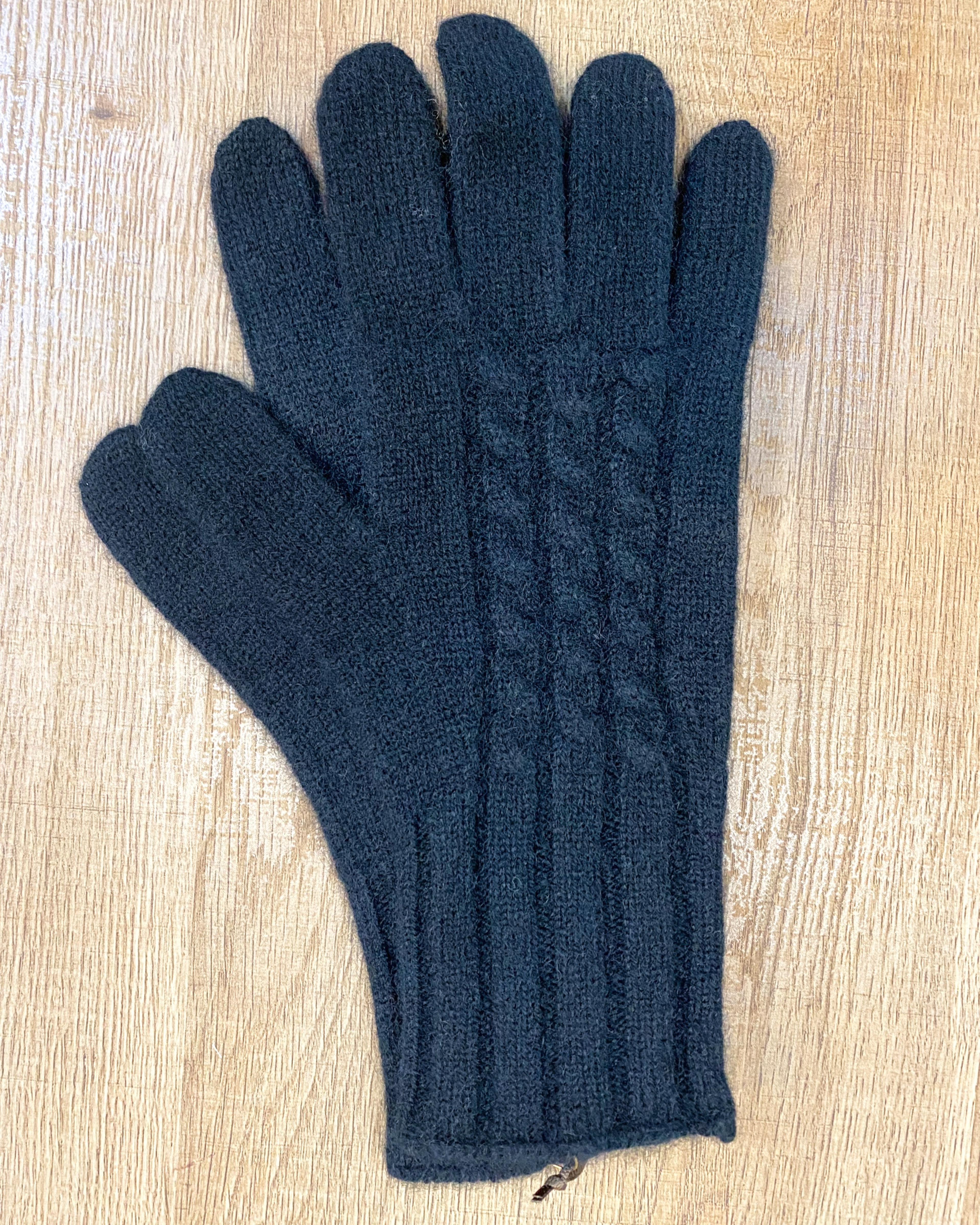 Unur model wearing black cable knit yak wool gloves