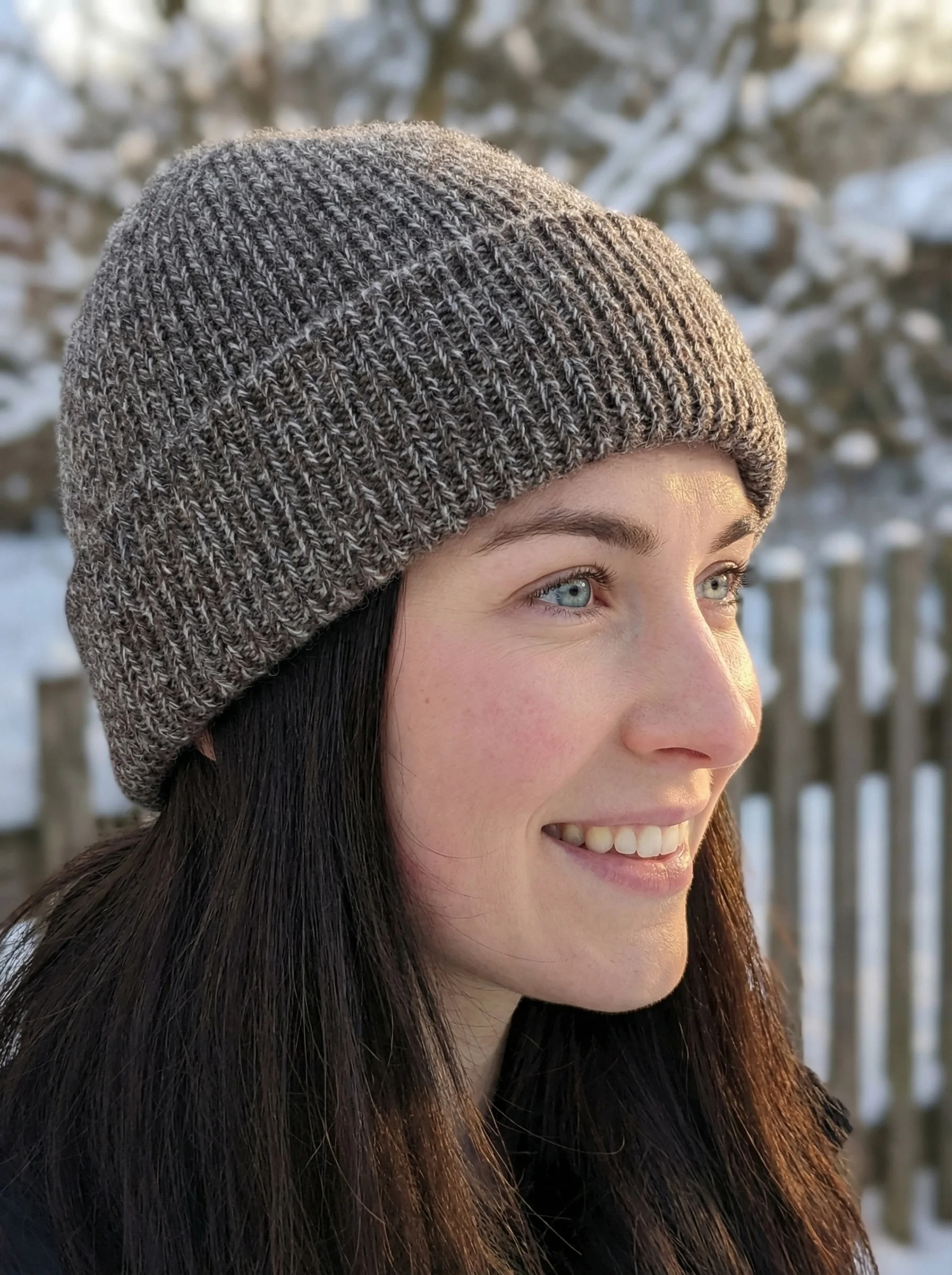 Woman outdoors wearing a mottled brown-white ribbed yak wool hat