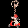 Rose gold dog on a scooter shape keychain with silver and crystal design