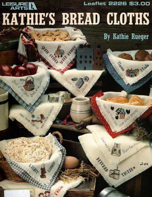Leisure Arts Kathie's Bread Cloths Counted Cross Stitch Pattern leaflet. Kathie Rueger. Made From Scratch, Light Lunch, Give Us This Day, Home Made, Fruit of Our Labor, Seasoned to Purrfection, Kitchen Tested, Farm Fresh, Snack Attack, Calorie Cutters.