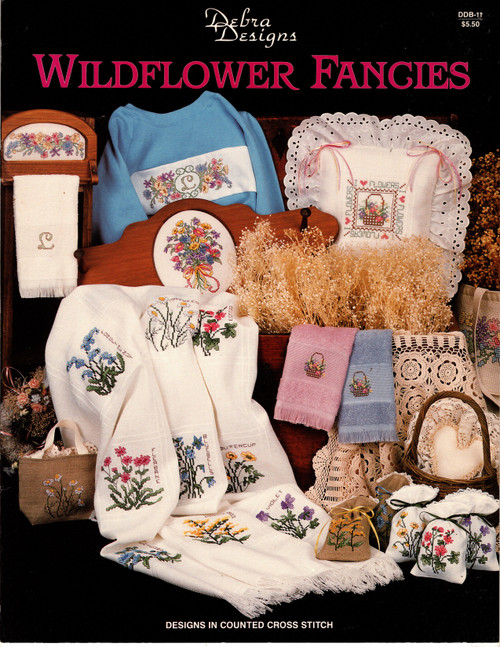 Debra Designs Wildflower Fancies counted cross stitch booklet. Debra Lambein. Poppy, Goldfields, Sweet William, Forget Me Not, Mayweed, Mallow, Fleabane, Bluebells, Buttercup, Chicory, Goldenrod, Violet, Floral Border, Floral Monogram with Border, I Love Flowers, Wildflower Bouquet