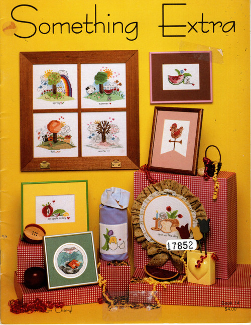 Barbara & Cheryl Something Extra counted cross stitch pattern booklet. Silver Lining, Spring, Summer, Fall, Winter, Let's Eat, Apple A Day, Hello World, Baby's First Christmas, Peace on Earth, Country Christmas, Tennis Shoes, Ballet Slipper, Happy Easter, Boo, Goldie, Littlest Angel, Sunny Day, Give Us This Day, Party Time, Good Morning