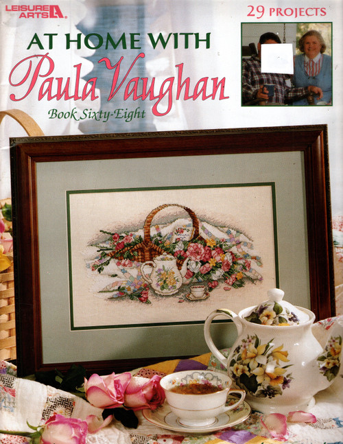 Leisure Arts At Home with Paula Vaughan Bk 68 Counted Cross Stitch Pattern booklet. Paula Vaughan. Full color charted designs. Front Porch Paradise, Flowery Welcome Wreath, Poetic Splendor, Daffodil Delights, Daffodil Bookmark, Rose Bookmark, Remembrance Album, Rose Bouquet Afghan, Heirloom Hope Chest, Sitting Pretty, Roses Alphabet, Rosebud Mini Cloth, Wild Rose, Milady's Towel, Rose Bouquet Sweater, Sweet Little Sachet Dainty Jar, Regal Rose Clock, Fancy Fan Patchwork Pillow, Song of the Seamstress, Stitcher's Companion, Sewing Room Door Sign, Fan Quilt Needle Case, Dresden Plate Sachet, Violet Pincushion, Violet Scissors Case, Inviting Gateway, Enchanting Moments Garden Sign Leisure Arts At Home with Paula Vaughan Bk 68 Counted Cross Stitch Pattern booklet. Paula Vaughan. Full color charted designs. Front Porch Paradise, Flowery Welcome Wreath, Poetic Splendor, Daffodil Delights, Daffodil Bookmark, Rose Bookmark, Remembrance Album, Rose Bouquet Afghan, Heirloom Hope Chest, Sitting Pretty, Roses Alphabet, Rosebud Mini Cloth, Wild Rose, Milady's Towel, Rose Bouquet Sweater, Sweet Little Sachet Dainty Jar, Regal Rose Clock, Fancy Fan Patchwork Pillow, Song of the Seamstress, Stitcher's Companion, Sewing Room Door Sign, Fan Quilt Needle Case, Dresden Plate Sachet, Violet Pincushion, Violet Scissors Case, Inviting Gateway, Enchanting Moments Garden Sign