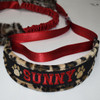 Padded dog collar with embroidered name and paw prints. 