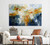 The brushwork forms elegant circular and oval rings that float across the canvas over a background of deep navy blue in the lower half and soft, airy washes of beige, pale sky blue and light gray in the upper half. 