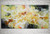 Large abstract painting with yellow, green and orange rust.