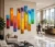Rainbow 9 panel original painting installed in modern corporate lobby - colorful tall vertical textured art for lobby design Montreal