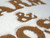 Warm & Cosy Cream Faux Fur Decorative Cushion with Brown Embroidered Lettering