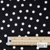 Wipe Clean Tablecloth Fabric. Loneta: Fantasy Dots - Black. Shown with a metre rule to display scale.