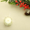 Lurex Christmas Wipe Clean Tablecloth: Panama Gold - pictured with a votive tealight candle and seasonal greenery.