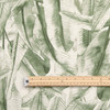 Wipe Clean Fabric - Navarra: Leaves - Green. Pictured with a wooden metre rule to show scale.
