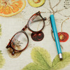 Acrylic coated tablecloth: Digital Harvest - pictured with a pair of glasses and a pen