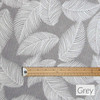 Wipe clean fabric. Living Feathers - Grey. Pictured with a cup and saucer, 'phone, pen and coins.