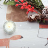 Wipe clean tablecloth: Living Nicholas. Pictured with a votive tealight candle and seasonal greenery.