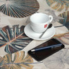 Wipe Clean Tablecloth - Digital: Kalani - Russet.  Pictured with a cup and saucer, 'phone, pen and coins.