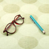 Living Circles - Beige: Wipe Clean Fabric. Pictured with a pair of glasses and a pen.