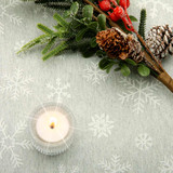 Living Sparkle Grey Acrylic Coated Fabric. Pictured with a votive tealight candle and seasonal greenery to show scale.