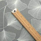 Acrylic Coated Tablecloth - Culla: Ginkgo in Grey. Pictured with a wooden metre rule sto show scale.