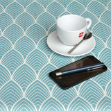 Wipe Clean Tablecloth - Navarra: Mayor Aqua.  Pictured with a cup, saucer and phone