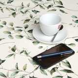 Wipe Clean Tablecloth - Navarra: Garcia.  Pictured with a cup, saucer and phone