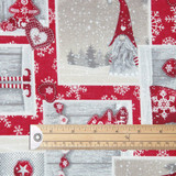 Symphony: Christmas Gnomes Wipe Clean Fabric pictured with a wooden ruler to show scale