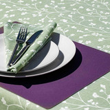 Blaze Sprig Sage Wipe Clean Fabric pictured on a table setting.