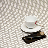 Acrylic Coated Tablecloth - Living: Fish - pictured with a phone, pen, cup and saucer.