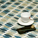Acrylic Coated Tablecloth - Living: Surf - pictured with a phone, pen, cup and saucer.