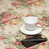 Acrylic Coated Tablecloth - Mirha Renaissance - pictured with a cup, saucer, phone and pen.