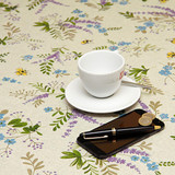 Wipe Clean Tablecloth - Mirha Bees - pictured with a cup, saucer, phone and pen