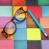 Wipe Clean Tablecloth - Digital Troy. Pictured on a table with a pair of glasses and a pen