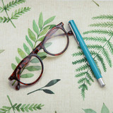 Wipe Clean Tablecloth - Digital Freya. Pictured with a pair of glasses and a pen.