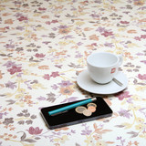 Wipe Clean Tablecloth - Blaze: Tia. Pictured with a cup and saucer, 'phone, pen and coins.